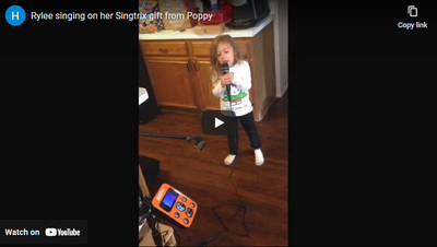 Rylee singing on her Singtrix gift from Poppy